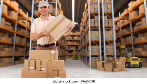 Deliveryman carrying a parcel in a distribution warehouse