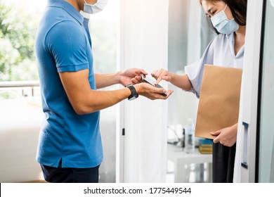 Deliveryman Delivering Package Food Order Customer At Home Signing Signature On Tablet Wearing Face Mask Safety Covid-19 Infection Customer Delivery Service Logistics Ordering Mail Posting Business  