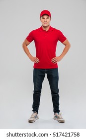 Deliveryman. full length portrait. isolated gray background