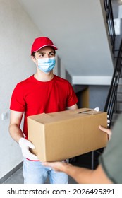 Deliveryman Wearing Mask Carry Small Box Deliver To Customer In Front Of Door At Home. Man Wearing Mask Prevent Covid19, Corana Virus Affection Outbreak. Social Distancing Work Concept.