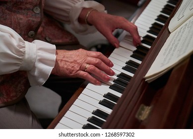 Delmenhorst, Germany - December 26, 2018: hands of an old lady in festive dress playing the piano