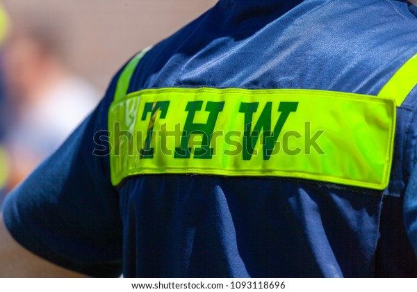 Delmenhorst / Germany - May 6, 2018:\
German technical emergency service sign on a vest from a man. THW,\
Technisches Hilfswerk means technical emergency\
service.