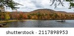 Delta, Alabama, USA- Nov. 11, 2021: Panorama of Cheaha Lake at the base of Mount Cheaha in Cheaha State Park in full autumn color.