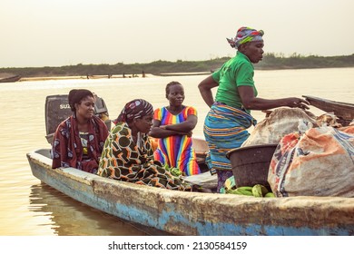 Delta State, Nigeria - December 9, 2021: Use of Water Transportation in African Communities. Commercial use of African Rivers. Buying and Selling in Rural Environment. Fishing in African Villages.