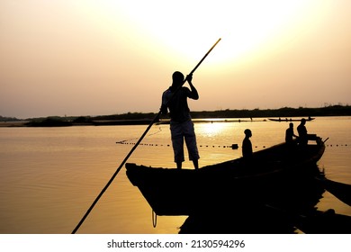 Delta State, Nigeria - December 9, 2021: African Fishermen Setting Out For Fishing Adventure. Fishery Business In Africa.
Fishing Boats By A River Bank. Reflection On A Water Surface.