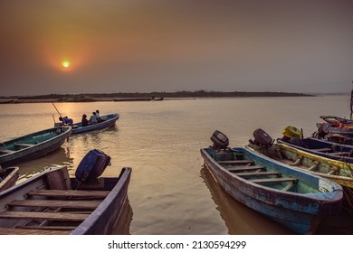 Delta State, Nigeria - December 9, 2021: African Fishermen setting out for fishing adventure. Fishery Business in Africa.
Fishing Boats by a River Bank. Reflection on a Water Surface.