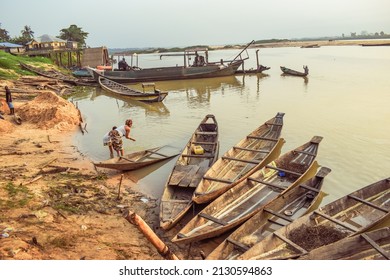 Delta State, Nigeria - December 9, 2021: African Fishermen Setting Out For Fishing Adventure. Fishery Business In Africa.
Fishing Boats By A River Bank. Reflection On A Water Surface.