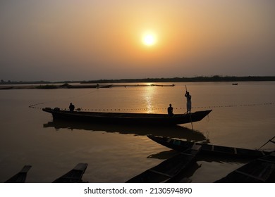 Delta State, Nigeria - December 9, 2021: African Fishermen Setting Out For Fishing Adventure. Fishery Business In Africa.
Fishing Boats By A River Bank. Reflection On A Water Surface.