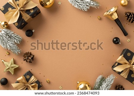Deluxe Season's Greetings arrangement. Top view of gifts, premium tree embellishments, balls, star decor, glittering sequins, jingling bell, frosty pine on terracotta backdrop with frame for message
