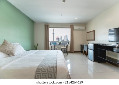 Deluxe spacious hotel room interior with views of the Toronto skyline. Luxury condo accommodation.