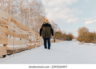 Delve into the serenity of a Caucasian hiker walking solo snowy hike, as he embraces the tranquility of the winter landscape and the simplicity of a solitary walk. - Powered by Shutterstock