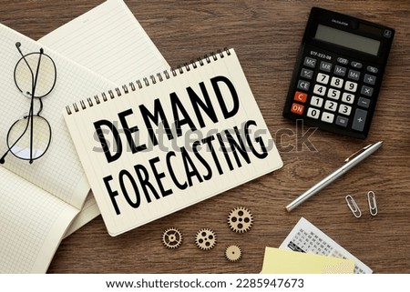 Demand Forecasting.top view on notebook stickers calculator and paper clips.text on page