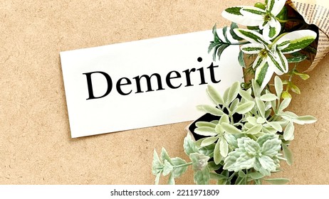 Demerit letters and plants on white paper on corkboard - Shutterstock ID 2211971809