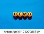 Demo symbol. Concept word Demo on beautiful yellow ping pong balls. Beautiful blue table blue background. Business and demo concept. Copy space.