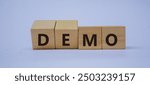 DEMO symbol. Copy space. Concept word DEMO on wooden blocks with blue background. Business and financial concept.