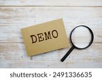 Demo text message and magnifying glass with space copy on wooden background