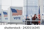 Democratic Process: American Flag on a Voting Booth in a Modern Polling Place in a Financial District. Secretary Working in a Distance. Elections Day with Patriotic United States of America Imagery