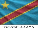 Democratic Republic of the Congo flag depicted on folded wavy fabric of old cloth close up