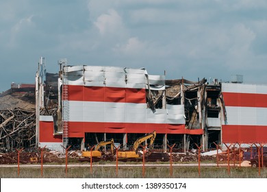 Demolished Industrial Building After Fire With Broken Roof, Walls And Piles Of Garbage. Burned Inside Warehouse Exterior.