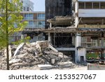Demolished old building being desmantled on a construction site. Useful building materials and resources being thrown away, not recycled. Ecology, recycling, circular economy concept