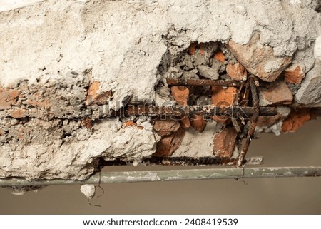 Demolition of a brick wall with iron rods rusted , abstract textures close up