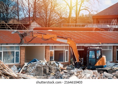 Demolition Of Building. Excavator Breaks Old House. Making Space For The Construction Of A New Houses