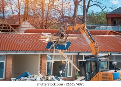 Demolition Of Building. Excavator Breaks Old House. Making Space For The Construction Of A New Houses