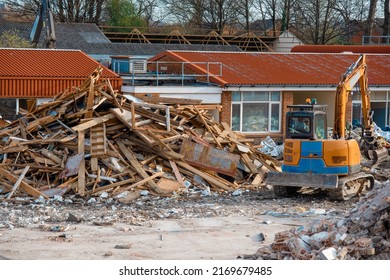 Demolition Of Building. Excavator Breaks Old House. Making Space For The Construction Of A New Houses