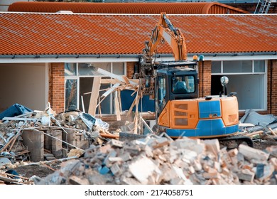 Demolition Of Building. Excavator Breaks Old House. Making Space For The Construction Of A New Houses