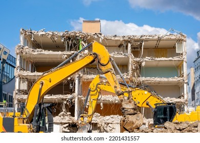 Demolition Of Building. Excavator Breaks Old House. Making Space For The Construction Of A New Houses