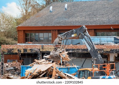 Demolition Of Building. Excavator Breaks Old House. Making Space For The Construction Of A New Houses