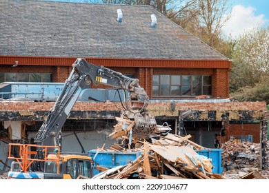 Demolition Of Building. Excavator Breaks Old House. Making Space For The Construction Of A New Houses