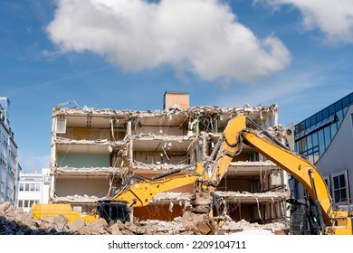 Demolition Of Building. Excavator Breaks Old House. Making Space For The Construction Of A New Houses