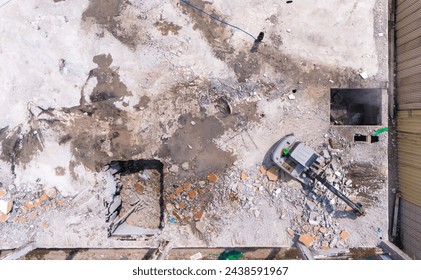 demolition of a building, excavator working, remains of a collapsed building, bird's eye view, building dismantling, construction site, 100 meters in height, Aerial view - Powered by Shutterstock