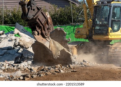 Demolition machine that crushes reinforced concrete, demolition site, construction industry
