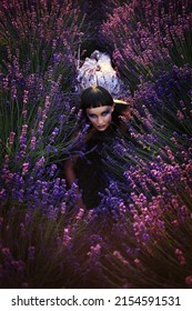 Demon Mask On Model Crawling Over Lavender Field At The Night