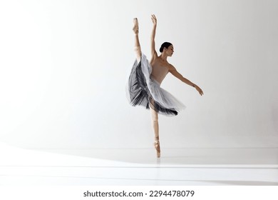 Demonstrate flexibility. Young and incredibly beautiful ballerina is posing and dancing in a white studio. Concept of beauty classical ballet art. Aesthetic of ballet, inspiration. - Powered by Shutterstock