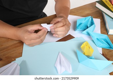 Demonstrate the process of origami step by step