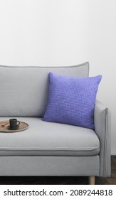 Demonstrating color of 2022 year very peri in interior. Gray sofa with violet or purple pillow in modern scandinavian style room interior. Vertical crop for social media, copy space - Shutterstock ID 2089244818