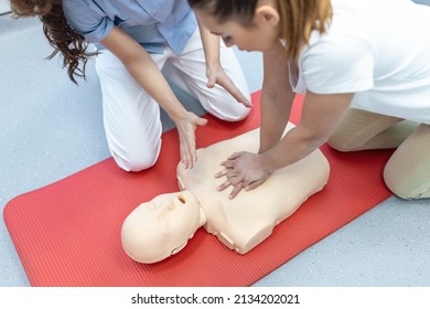 Demonstrating CPR (Cardiopulmonary Resuscitation) Training Medical Procedure On CPR Doll In The Class.Doctor And Nurse Students Are Learning How To Rescue The Patient.First Aid For Safe Life Concept.