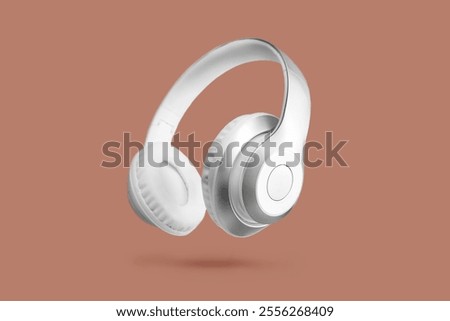 Demonstrating Mocha mousse color of the year 2025. White wireless headphones in the air on brown background.