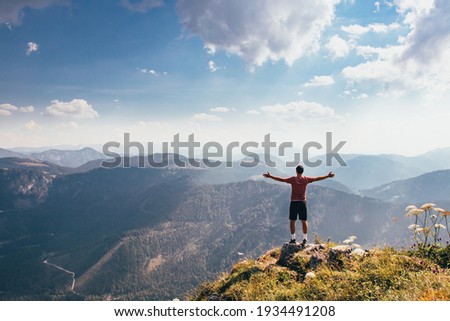 Demonstrating one's own fitness skills and self-satisfaction. A feeling of victory and fulfillment of your goal on Mount Otscher in the lower-western Austrian Alps.