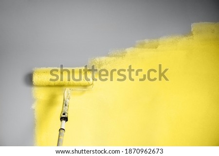 Demonstrating trendy Color of the Year 2021. Illuminating Yellow and Ultimate Gray. Brush and open paint can with on color background. Appartment renovation, repair, building and home design concept.