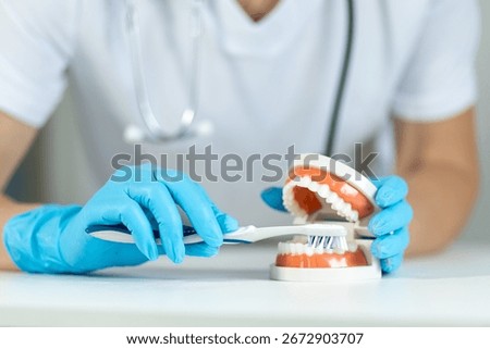 Demonstration of proper teeth brushing technique using dental model in a clinical setting