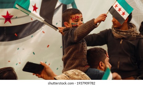 Demonstrations of the tenth anniversary of the Syrian revolution. Syrian child carrying the flag of the Syrian revolution. The conflict in Syria
Aleppo, Syria 16 March