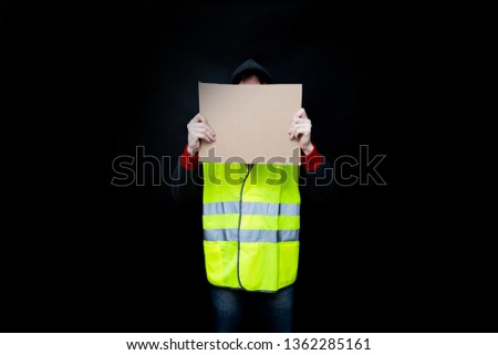 Demonstrators in yellow vests with a cardboard blank sign, the protest of the population in France against the increase in the cost of fuel, excessive living expenses and high taxes, gilets jaunes 