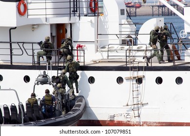 DEN HELDER, THE NETHERLANDS - JULY 7: Dutch Marines entering a ship during an anti piracy demonstrion at the Dutch Navy Days on July 7, 2012 in Den Helder, The Netherlands