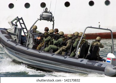 DEN HELDER, THE NETHERLANDS - JULY 7: Dutch Marines about to enter a ship during an anti piracy demonstrion at the Dutch Navy Days on July 7, 2012 in Den Helder, The Netherlands