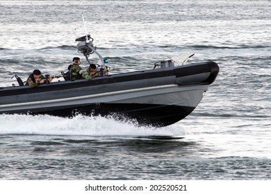 DEN HELDER, THE NETHERLANDS - JULY 7: Dutch Marines in a speedboat during an assault demo at the Dutch Navy Days on July 7, 2012 in Den Helder, The Netherlands 