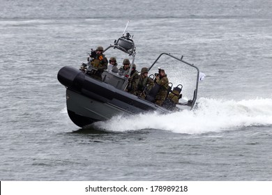 DEN HELDER, THE NETHERLANDS - JUNE 23: Dutch Marines in a speedboat during an assault demo at the Dutch Navy Days on June 23, 2013 in Den Helder, The Netherlands 